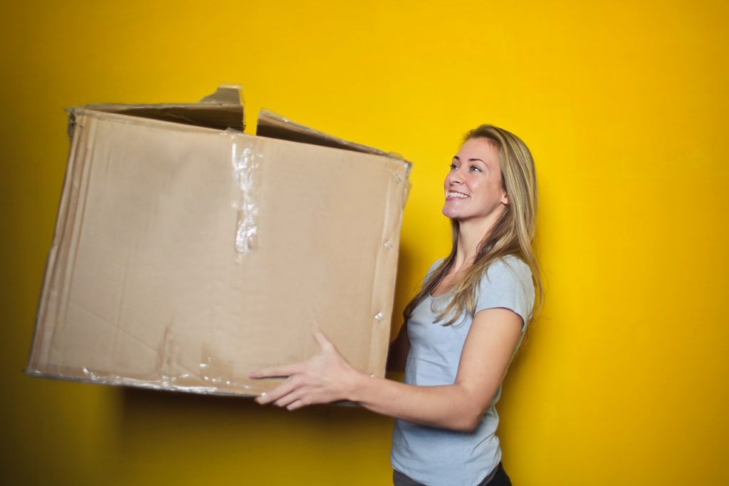Image of happy person moving a box